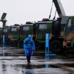 A security member walks in the rain past the Type 780 target designation radar displayed at the China International Aviation and Aerospace Exhibition, or Airshow China, in Zhuhai, Guangdong province, China November 14, 2024. REUTERS/Tingshu Wang