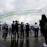Visitors watch aircraft of the Chinese People's Liberation Army (PLA) Air Force's Bayi aerobatic team perform at the China International Aviation and Aerospace Exhibition, or Airshow China, in Zhuhai, Guangdong province, China November 14, 2024. REUTERS/Tingshu Wang
