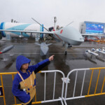 A visitor stands next to a CH-9 combat drone displayed at the China International Aviation and Aerospace Exhibition, or Airshow China, in Zhuhai, Guangdong province, China November 14, 2024. REUTERS/Tingshu Wang TPX IMAGES OF THE DAY
