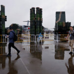 Visitors walk past surface-to-air missile weapon system displayed at the China International Aviation and Aerospace Exhibition, or Airshow China, in Zhuhai, Guangdong province, China November 14, 2024. REUTERS/Tingshu Wang