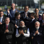 Bolivian President Luis Arce, Portugal's Prime Minister Luis Montenegro, Turkish President Tayyip Erdogan, European Commission President Ursula von der Leyen, European Council President Charles Michel, Argentina's President Javier Milei, India's Prime Minister Narendra Modi, Japan's Prime Minister Shigeru Ishiba, French President Emmanuel Macron, German Chancellor Olaf Scholz, Mexico's President Claudia Sheinbaum and Brazil's President Luiz Inacio Lula da Silva applaud as they pose for a group photo at the G20 summit, in Rio de Janeiro, Brazil, November 18, 2024. REUTERS/Ricardo Moraes