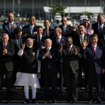 Bolivian President Luis Arce, Portugal's Prime Minister Luis Montenegro, Turkish President Tayyip Erdogan, European Commission President Ursula von der Leyen, European Council President Charles Michel, Argentina's President Javier Milei, India's Prime Minister Narendra Modi, Japan's Prime Minister Shigeru Ishiba, French President Emmanuel Macron, German Chancellor Olaf Scholz, Mexico's President Claudia Sheinbaum, South Africa's President Cyril Ramaphosa, China's President Xi Jinping, South Korea's President Yoon Suk Yeol, Saudi Foreign Minister Prince Faisal bin Farhan Al-Saud, Russia's Foreign Minister Sergei Lavrov, Britain's Prime Minister Keir Starmer and Brazil's President Luiz Inacio Lula da Silva applaud as they pose for a group photo at the G20 summit, in Rio de Janeiro, Brazil, November 18, 2024. REUTERS/Ricardo Moraes