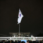 South Korean flag hangs on a pole outside the gate of the National Assembly, after South Korean President Yoon Suk Yeol declared martial law, in Seoul, South Korea, December 4, 2024. REUTERS/Kim Hong-Ji