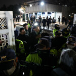 Police officers close the gate of the National Assembly, after South Korean President Yoon Suk Yeol declared martial law, in Seoul, South Korea, December 4, 2024. REUTERS/Kim Hong-Ji