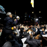 People gesture outside the National Assembly, after South Korean President Yoon Suk Yeol declared martial law, in Seoul, South Korea, December 4, 2024. REUTERS/Kim Soo-hyeon