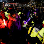 A man speaks to police officers outside the National Assembly, after South Korean President Yoon Suk Yeol declared martial law, in Seoul, South Korea, December 4, 2024. REUTERS/Kim Soo-hyeon