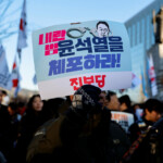 A demonstrator holds a sign as people take part in a rally to demand South Korean President Yoon Suk Yeol's removal from power, in Seoul, South Korea, December 4, 2024. The sign reads, "Arrest the insurrectionist Yoon Suk Yeol". REUTERS/Kim Soo-hyeon