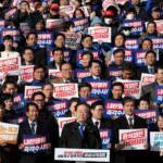 South Korea's main opposition Democratic Party leader Lee Jae-myung looks on as people hold placards that read "Step down President Yoon Suk Yeol" and "Investigate his act of rebellion immediately", at a rally to condemn South Korean President’s surprise declarations of the martial law last night and to call for his resignation, at the national assembly in Seoul, South Korea, December 4, 2024. REUTERS/Kim Hong-Ji