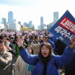 People hold placards that read "Step down President Yoon Suk Yeol" and "Investigate his act of rebellion immediately", at a rally to condemn South Korean President’s surprise declarations of the martial law last night and to call for his resignation, at the national assembly in Seoul, South Korea, December 4, 2024. REUTERS/Kim Hong-Ji