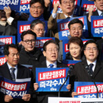 South Korea's main opposition Democratic Party leader Lee Jae-myung holds a sign reading "Investigate his act of rebellion immediately", at a rally to condemn South Korean President?s surprise declarations of the martial law last night and to call for his resignation, at the national assembly in Seoul, South Korea, December 4, 2024. REUTERS/Kim Hong-Ji