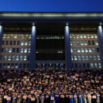People hold candles and signs during a candlelight vigil to demand the resignation of South Korean President Yoon Suk Yeol, who declared martial law which was reversed hours later, at the National Assembly in Seoul, South Korea, December 5, 2024. REUTERS/Kim Hong-ji