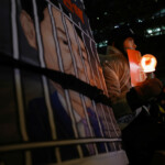 A protester attends a candlelight vigil to condemn South Korean President Yoon Suk Yeol's surprise declarations of the failed martial law and to call for his resignation in Seoul, South Korea, December 5, 2024. REUTERS/Kim Kyung-Hoon