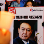 Protesters hold placards during a candlelight vigil to condemn South Korean President Yoon Suk Yeol's surprise declarations of the failed martial law and to call for his resignation in Seoul, South Korea, December 5, 2024. REUTERS/Kim Kyung-Hoon