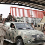 Syrian forces cross the border through gates, in Al Qaim, Iraq, in this still image taken from a video released on December 7, 2024. Video obtained by Reuters/via REUTERS