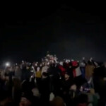 People celebrate after the statue of former President of Syria Hafez al-Assad is toppled by the crowd in Homs, Syria in this screengrab obtained from a social media video released on December 8, 2024. Social Media/via REUTERS