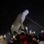 People cheer as the statue of former President of Syria Hafez al-Assad is toppled in Homs, Syria in this screengrab obtained from a social media video released on December 8, 2024. Social Media/via REUTERS