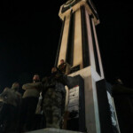 Rebel fighters gather in Homs as a Syrian opposition flag is put up on the clock tower, after Syria's army command notified officers on Sunday that President Bashar al-Assad's 24-year authoritarian rule has ended, a Syrian officer who was informed of the move told Reuters, following a rapid rebel offensive that took the world by surprise, in Homs, Syria December 8, 2024. REUTERS/Mahmoud Hasano
