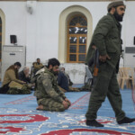 A rebel fighter prays in a mosque in Homs after Syria's army command notified officers on Sunday that President Bashar al-Assad's 24-year authoritarian rule has ended, a Syrian officer who was informed of the move told Reuters, following a rapid rebel offensive that took the world by surprise, in Homs, Syria December 8, 2024. REUTERS/Mahmoud Hasano