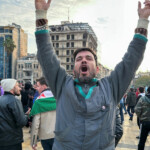 A man gestures at Saadallah al-Jabiri Square as people celebrate, after Syria's army command notified officers on Sunday that President Bashar al-Assad's 24-year authoritarian rule has ended, a Syrian officer who was informed of the move told Reuters, following a rapid rebel offensive that took the world by surprise, in Aleppo, Syria December 8, 2024. REUTERS/Karam al-Masri