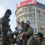 Rebel fighter kisses a child as they gather in Homs after Syria's army command notified officers on Sunday that President Bashar al-Assad's 24-year authoritarian rule has ended, Reuter Syria December 8, 2024. REUTERS/Mahmoud Hasano