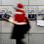 A person passes by placards with images of South Korean President Yoon Suk Yeol on the day of a rally calling for the impeachment of South Korean President Yoon Suk Yeol, who declared martial law, which was reversed hours later, near the National Assembly, in Seoul, South Korea, December 9, 2024. REUTERS/Kim Kyung-Hoon