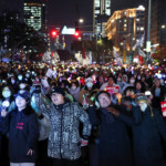 Protesters dance during a rally calling for the impeachment of South Korean President Yoon Suk Yeol, who declared martial law, which was reversed hours later, in front of the National Assembly in Seoul, South Korea, December 10, 2024. REUTERS/Kim Hong-Ji
