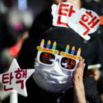 A protester wearing glasses that read "Impeachment" attends a rally calling for the impeachment of South Korean President Yoon Suk Yeol, who declared martial law, which was reversed hours later, in front of the National Assembly in Seoul, South Korea, December 10, 2024. REUTERS/Kim Hong-Ji