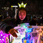 Shopkeeper sells light sticks that read "Yoon Suk Yeol OUT" during a rally calling for the impeachment of South Korean President Yoon Suk Yeol, who declared martial law, which was reversed hours later, in front of the National Assembly in Seoul, South Korea, December 10, 2024. REUTERS/Kim Hong-Ji