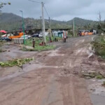 People walk on a damaged road, in the aftermath of the Cyclone Chido, in Mayotte, France, in this screengrab from a video obtained from social media, December 15, 2024. GENDARMERIE NATIONALE/via REUTERS