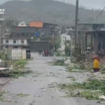 Locals stand on a street covered in debris after Cyclone Chido swept through Mayotte, France in this screengrab taken from a handout video obtained by Reuters on December 15, 2024. French Civil Security/Handout via REUTERS