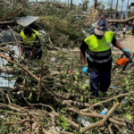 Rescue workers attempt to clear a blocked road, in the aftermath of Cyclone Chido, within Labattoir, in Mayotte, France, December 15, 2024. REUTERS/Chafion Madi