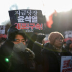 A man holds a poster that reads, "Arrest Yoon Suk Yeol immediately," as protesters rally against the impeached South Korean President Yoon Suk Yeol near his official residence, after investigators were unable to execute an arrest warrant on Friday for Yoon, according to the Corruption Investigation Office for High-ranking Officials, in Seoul, South Korea, January 3, 2025. REUTERS/Kim Hong-Ji