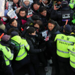 Anti-Yoon protesters try to break through police barricade as they make their way towards impeached South Korean President Yoon Suk Yeol's official residence, during a rally after investigators were unable to execute an arrest warrant on Friday for Yoon according to the Corruption Investigation Office for High-ranking Officials, in Seoul, South Korea, January 3, 2025. REUTERS/Kim Hong-Ji