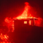 Flames rise from a beachfront home along the road to Malibu, as powerful winds fueling devastating wildfires in the Los Angeles area force people to evacuate, California, U.S. January 8, 2025. REUTERS/Mike Blake