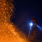 A firefighter standing on a ladder watches embers rise from a building on fire, as powerful winds fueling devastating wildfires in the Los Angeles area force people to evacuate, at the Eaton Fire in Altadena, California, U.S. January 8, 2025. REUTERS/Fred Greaves
