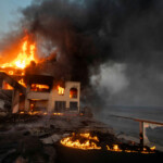 Flames rise from structures as the Palisades fire burns during a windstorm on the west side of Los Angeles, California, U.S. January 8, 2025. REUTERS/Ringo Chiu