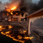 Flames and smoke rise from structures as the Palisades fire burns during a windstorm on the west side of Los Angeles, California, U.S. January 8, 2025. REUTERS/Ringo Chiu Los Angeles Wildfires
