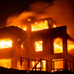 Flames rise from a structure as the Palisades fire burns during a windstorm on the west side of Los Angeles, California, U.S. January 8, 2025. REUTERS/Ringo Chiu