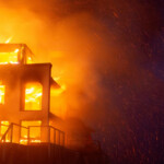 Flames rise from a structure as the Palisades fire burns during a windstorm on the west side of Los Angeles, California, U.S. January 8, 2025. REUTERS/Ringo Chiu