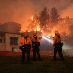 Firefighters operate as smoke and flames rise from the Sunset Fire in the hills overlooking the Hollywood neighborhood of Los Angeles, California, U.S. January 8, 2025. REUTERS/David Swanson