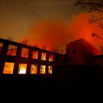 Smoke and flames rise from a burning structure, as powerful winds fueling devastating wildfires in the Los Angeles area force people to evacuate, at the Eaton Fire in Altadena, California, U.S. January 8, 2025. REUTERS/Fred Greaves