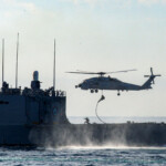 A Turkish navy ship and a helicopter take part in the Blue Homeland-Mavi Vatan 2025 military exercise in the Aegean, off the shores of Turkey's coastal town of Marmaris January 9, 2025. REUTERS/Kenan Gurbuz