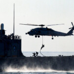 A Turkish navy ship and a helicopter take part in the Blue Homeland-Mavi Vatan 2025 military exercise in the Aegean, off the shores of Turkey's coastal town of Marmaris January 9, 2025. REUTERS/Kenan Gurbuz