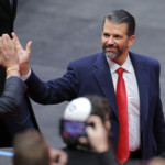 Donald Trump Jr. high fives a member of the crowd at Capital One arena on the inauguration day of Donald Trump's second presidential term, in Washington, U.S., January 20, 2025. REUTERS/Brian Snyder