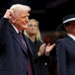 U.S. President Donald Trump gestures beside first lady Melania Trump during the inaugural parade inside Capital One Arena on the inauguration day of his second presidential term, in Washington, U.S. January 20, 2025. REUTERS/Carlos Barria