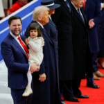 Vice President JD Vance carries Maribel next to Vivek, U.S. President Donald Trump and first lady Melania Trump at a rally on the inauguration day of Donald Trump's second Presidential term, inside Capital One Arena, in Washington, U.S. January 20, 2025. REUTERS/Brian Snyder