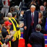 U.S. President Donald Trump looks at relatives of hostages from the deadly October 7, 2023 attack by Hamas, as he prepares to speak at Capital One Arena on the inauguration day of Trump's second presidential term, in Washington, U.S. January 20, 2025. REUTERS/Brian Snyder