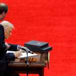U.S. President Donald Trump signs executive orders on the inauguration day of Trump's second Presidential term, inside Capital One Arena, in Washington, U.S. January 20, 2025. REUTERS/Brian Snyder