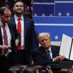 U.S. President Donald Trump shows his signature on an executive order that he signed in front of supporters inside the Capital One Arena as U.S. Vice President J.D. Vance looks on during ceremonies on the inauguration day of his second presidential term, in Washington, U.S. January 20, 2025. REUTERS/Amanda Perobelli