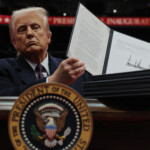 U.S. President Donald Trump presents the second executive order during the inaugural parade inside Capital One Arena on the inauguration day of his second presidential term, in Washington, U.S. January 20, 2025. REUTERS/Carlos Barria